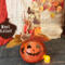 A fall pumpkin made from a dried gourd wearing a fancy custom made witch hat. Her name is Aster.